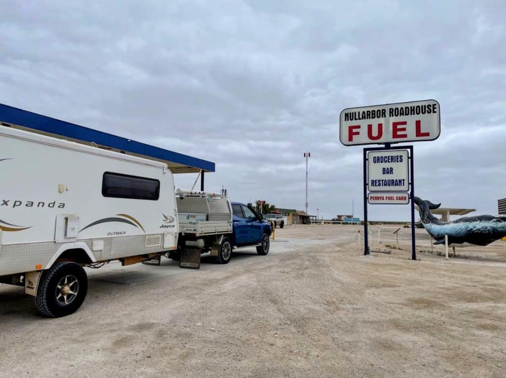 A caravanner in a Blue Triton towing an old Jayco Expanda to the Nullarbor Fuel stop