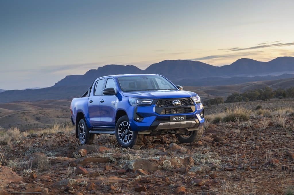 Hilux on rocky terrain with mountains in the background. Toyota is testing its Merge Assist technology using C-ITS hardware in Melbourne